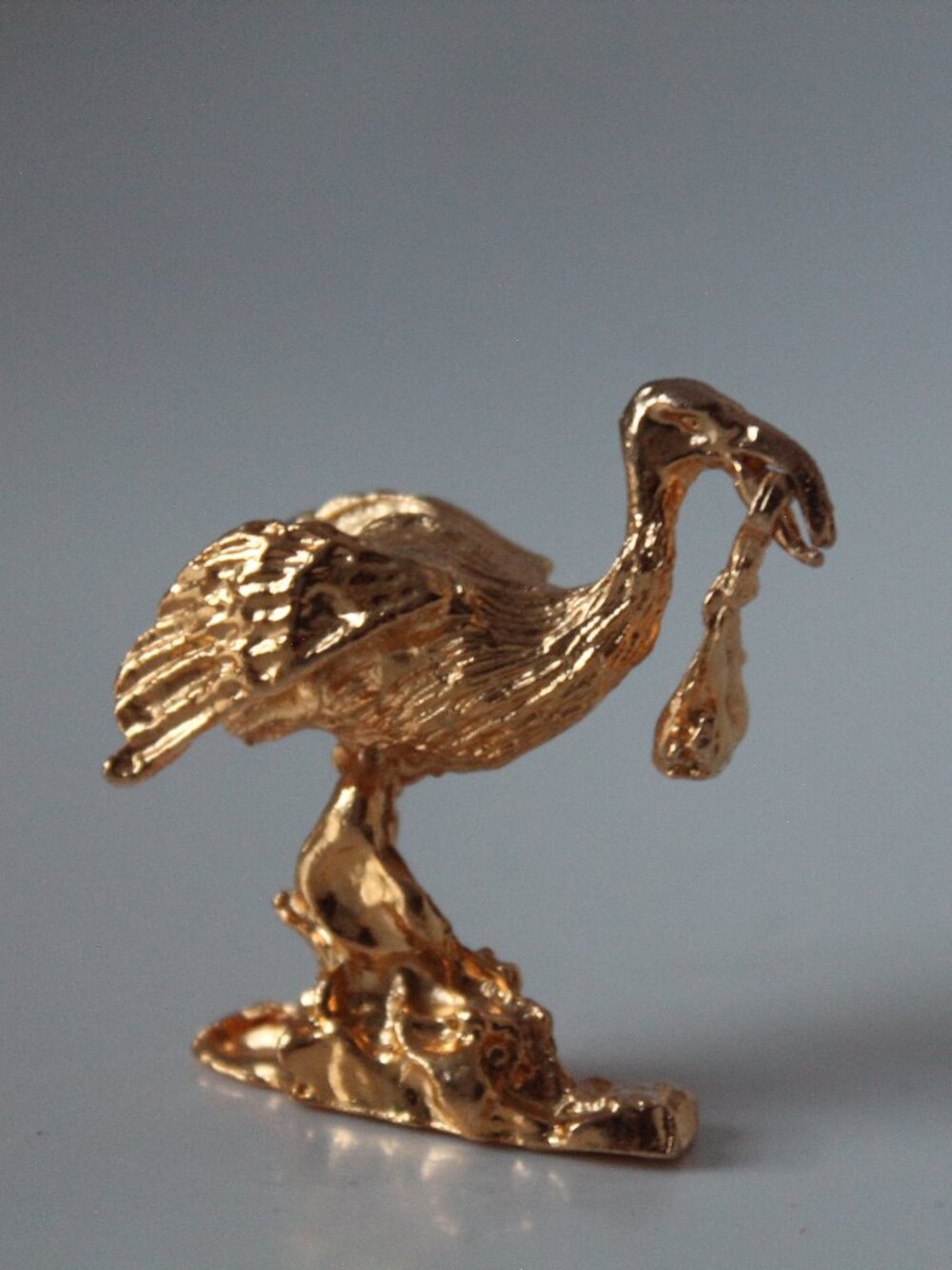 Miniature Golden Stork with Swinging Baby